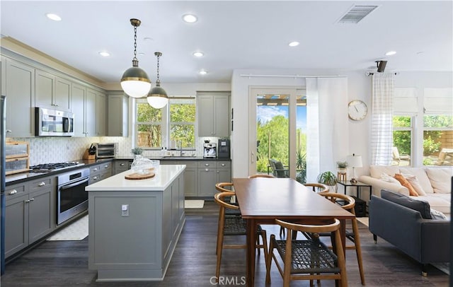 55 Fuchsia, Lake Forest, CA 92630 - kitchen featuring appliances with stainless steel finishes, gray cabinetry, a center island, decorative backsplash, and recessed lighting