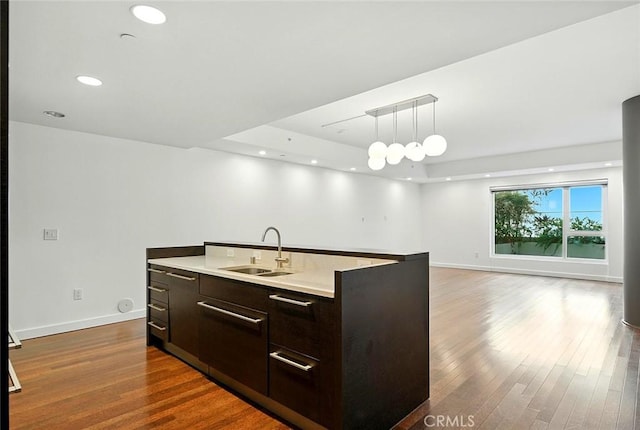6250 Hollywood Blvd Unit 4D, Los Angeles, CA 90028 - kitchen with modern cabinets, open floor plan, dark brown cabinets, dark wood-type flooring, and light countertops