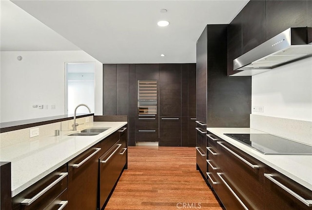 6250 Hollywood Blvd Unit 4D, Los Angeles, CA 90028 - kitchen with electric cooktop, wall chimney exhaust hood, light countertops, modern cabinets, and recessed lighting
