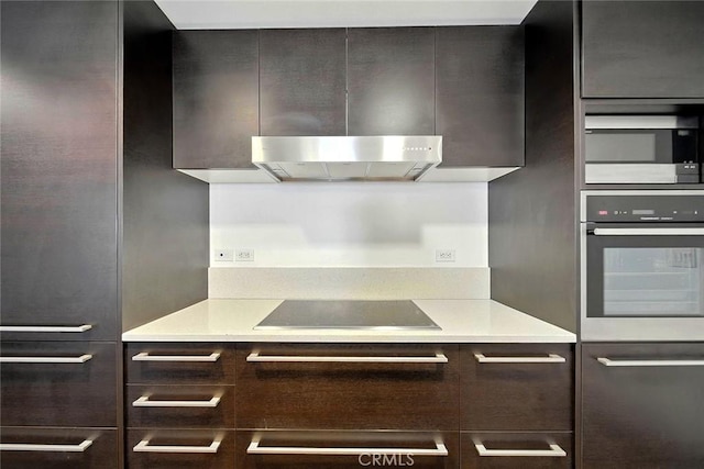 6250 Hollywood Blvd Unit 4D, Los Angeles, CA 90028 - kitchen featuring appliances with stainless steel finishes, modern cabinets, ventilation hood, light countertops, and dark brown cabinetry