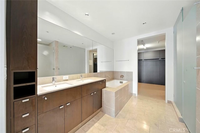 6250 Hollywood Blvd Unit 4D, Los Angeles, CA 90028 - bathroom featuring a bath, double vanity, and a spacious closet