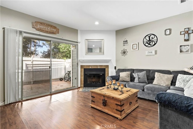 12301 Osborne St Unit 67, Pacoima, CA 91331 - living room with dark wood-style flooring, recessed lighting, and a tiled fireplace