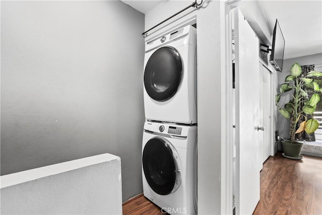 12301 Osborne St Unit 67, Pacoima, CA 91331 - washroom with stacked washing machine and dryer and wood finished floors