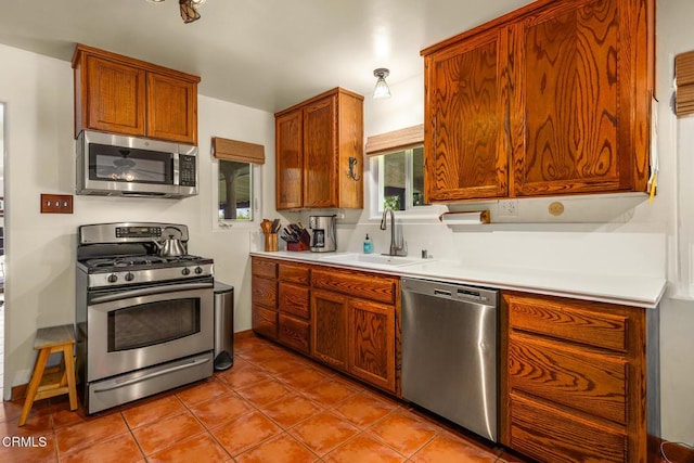 30370 Bouquet Canyon Rd, Santa Clarita, CA 91390 - kitchen featuring appliances with stainless steel finishes, light countertops, tile patterned floors, and brown cabinets