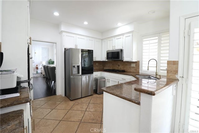 2430 Spring Meadow Dr, Chino Hills, CA 91709 - kitchen featuring appliances with stainless steel finishes, white cabinets, a peninsula, tasteful backsplash, and dark countertops