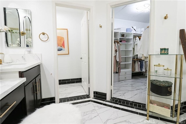 2430 Spring Meadow Dr, Chino Hills, CA 91709 - full bathroom with marble finish floors, vanity, and a walk in closet
