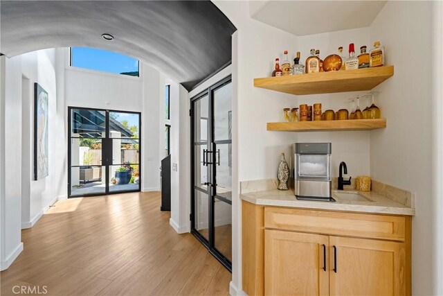 433 Emerald Bay Dr, Arroyo Grande, CA 93420 - kitchen featuring french doors, open shelves, light wood-style floors, light countertops, and light brown cabinetry