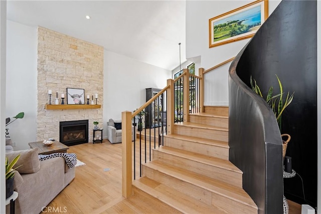 433 Emerald Bay Dr, Arroyo Grande, CA 93420 - stairs featuring a fireplace, wood finished floors, and a high ceiling