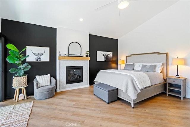 433 Emerald Bay Dr, Arroyo Grande, CA 93420 - bedroom with vaulted ceiling, light wood-style flooring, a glass covered fireplace, ceiling fan, and recessed lighting