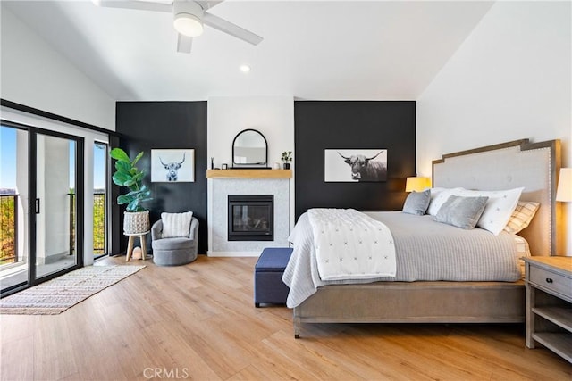 433 Emerald Bay Dr, Arroyo Grande, CA 93420 - bedroom featuring wood finished floors, a glass covered fireplace, vaulted ceiling, access to exterior, and recessed lighting