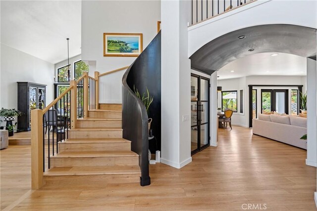 433 Emerald Bay Dr, Arroyo Grande, CA 93420 - stairs featuring arched walkways, wood finished floors, recessed lighting, and high vaulted ceiling