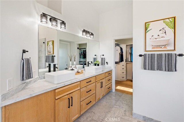 433 Emerald Bay Dr, Arroyo Grande, CA 93420 - full bath featuring marble finish floors, double vanity, a walk in closet, a towering ceiling, and a shower