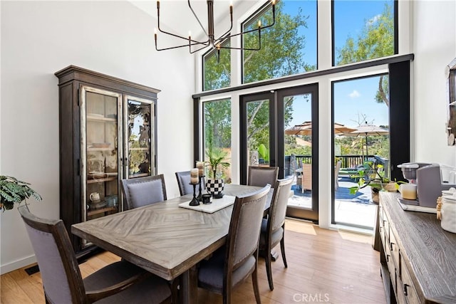 433 Emerald Bay Dr, Arroyo Grande, CA 93420 - dining room with a high ceiling, a chandelier, plenty of natural light, and light wood-type flooring