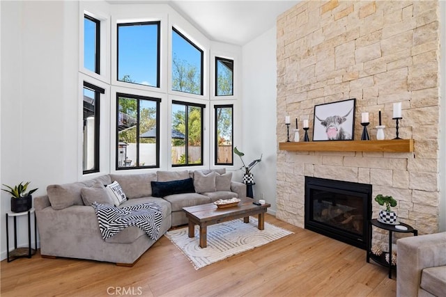 433 Emerald Bay Dr, Arroyo Grande, CA 93420 - living room with wood finished floors, a stone fireplace, and a high ceiling