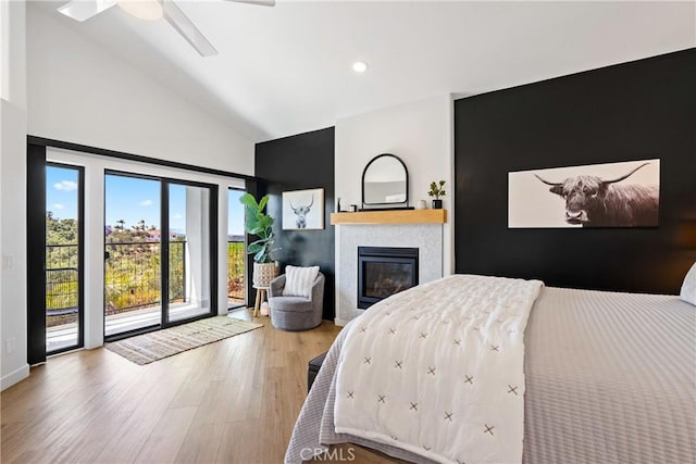 433 Emerald Bay Dr, Arroyo Grande, CA 93420 - bedroom with access to outside, a glass covered fireplace, wood finished floors, high vaulted ceiling, and recessed lighting
