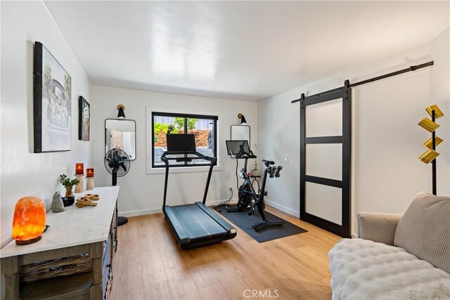 433 Emerald Bay Dr, Arroyo Grande, CA 93420 - exercise room with a barn door and light wood-style flooring