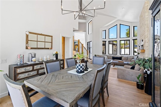 433 Emerald Bay Dr, Arroyo Grande, CA 93420 - dining space featuring light wood-style flooring, a high ceiling, and a chandelier