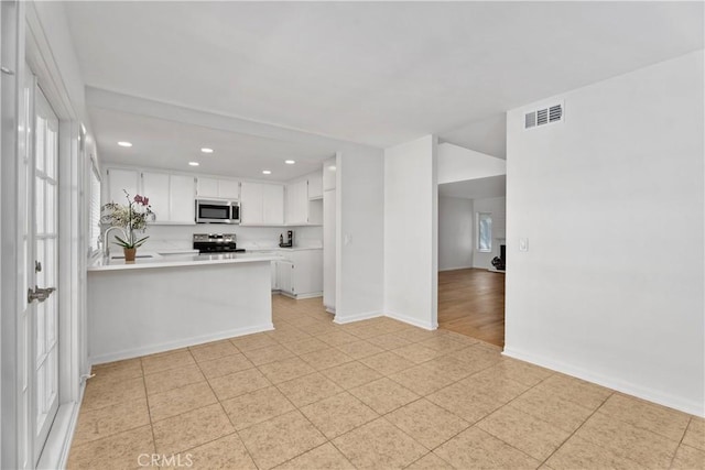 18 Denver Unit 71, Irvine, CA 92604 - kitchen with appliances with stainless steel finishes, recessed lighting, light countertops, a peninsula, and white cabinets
