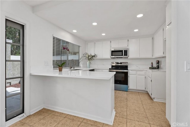 18 Denver Unit 71, Irvine, CA 92604 - kitchen featuring appliances with stainless steel finishes, a peninsula, recessed lighting, light countertops, and white cabinetry