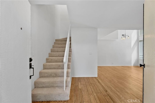 18 Denver Unit 71, Irvine, CA 92604 - stairway featuring hardwood / wood-style floors and a chandelier