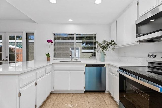 18 Denver Unit 71, Irvine, CA 92604 - kitchen featuring appliances with stainless steel finishes, a peninsula, recessed lighting, and white cabinets
