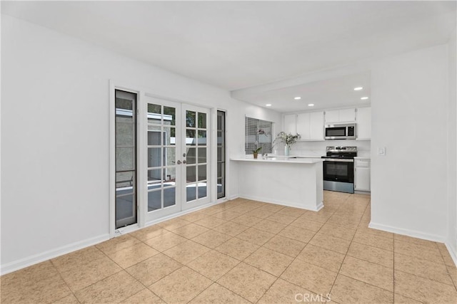 18 Denver Unit 71, Irvine, CA 92604 - kitchen with stainless steel appliances, light countertops, a peninsula, recessed lighting, and white cabinets