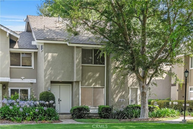 18 Denver Unit 71, Irvine, CA 92604 - townhome / multi-family property featuring roof with shingles and stucco siding