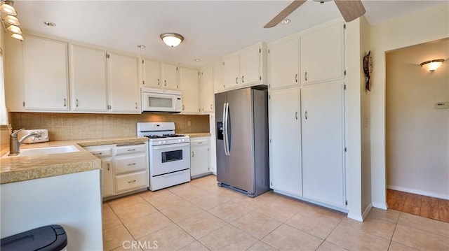 448 Delle Dr, Crestline, CA 92325 - kitchen featuring white appliances, light tile patterned flooring, light countertops, decorative backsplash, and ceiling fan