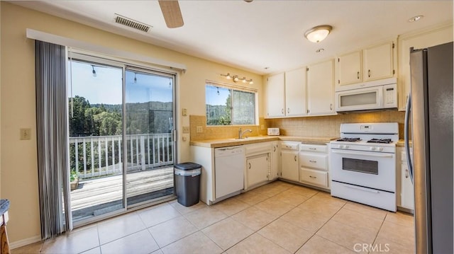 448 Delle Dr, Crestline, CA 92325 - kitchen with white appliances, light countertops, tasteful backsplash, and light tile patterned flooring