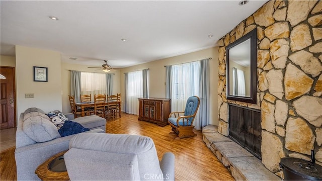 448 Delle Dr, Crestline, CA 92325 - living area with a fireplace, light wood-style floors, and a ceiling fan