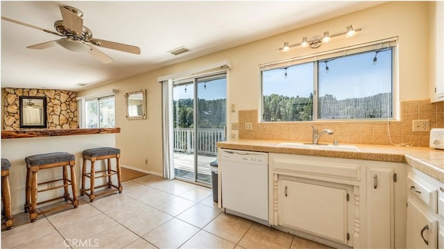 448 Delle Dr, Crestline, CA 92325 - kitchen featuring dishwasher, tasteful backsplash, light countertops, and healthy amount of natural light