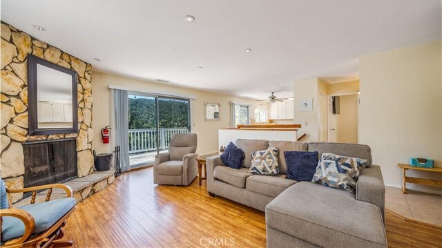 448 Delle Dr, Crestline, CA 92325 - living room featuring light wood-type flooring and a stone fireplace