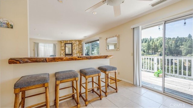 448 Delle Dr, Crestline, CA 92325 - kitchen featuring a kitchen breakfast bar, light tile patterned floors, a ceiling fan, and recessed lighting