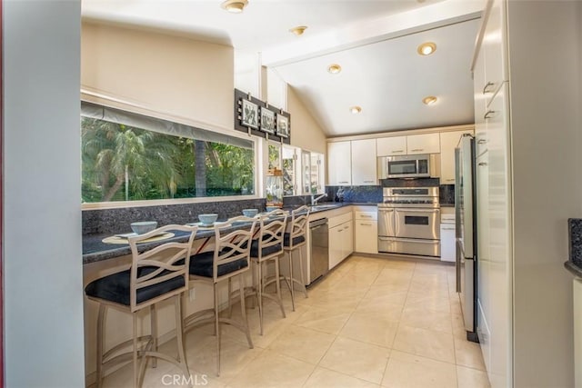 31781 National Park Dr, Laguna Niguel, CA 92677 - kitchen featuring appliances with stainless steel finishes, tasteful backsplash, dark countertops, and light tile patterned flooring