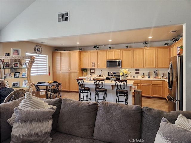 37882 Lopez Ln, Palmdale, CA 93552 - living area featuring light wood finished floors, recessed lighting, and high vaulted ceiling