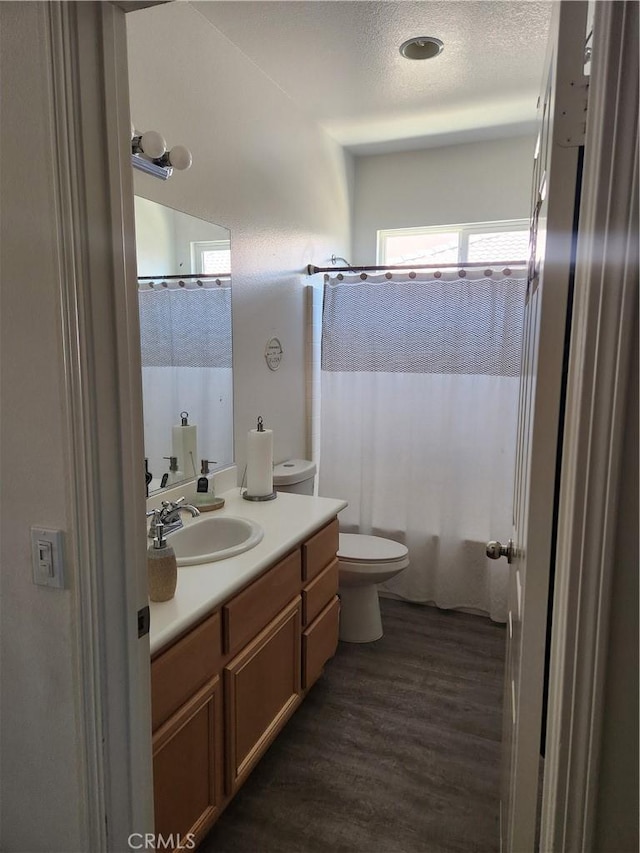 37882 Lopez Ln, Palmdale, CA 93552 - full bathroom featuring vanity, wood finished floors, shower / bath combo, and a textured ceiling