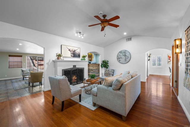1415 Rex Ln, El Cajon, CA 92021 - living room featuring arched walkways, lofted ceiling, a warm lit fireplace, ceiling fan, and wood finished floors