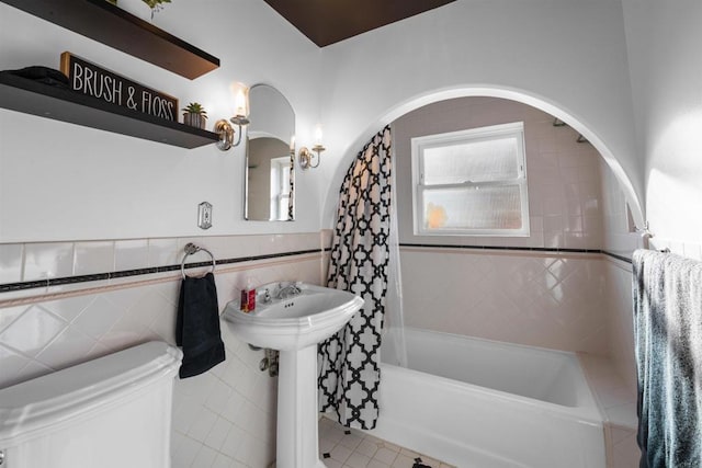 1415 Rex Ln, El Cajon, CA 92021 - bathroom with shower / bathtub combination with curtain, tile walls, a wainscoted wall, and tile patterned flooring