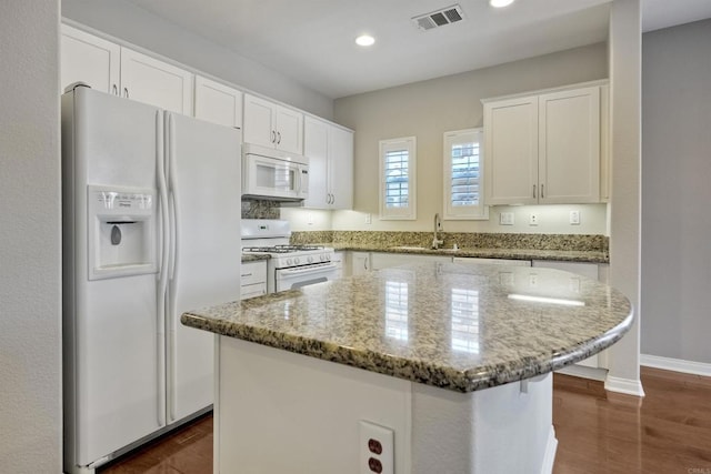 1440 Clearview Way, San Marcos, CA 92078 - kitchen with white appliances, white cabinetry, light stone countertops, a kitchen island, and recessed lighting