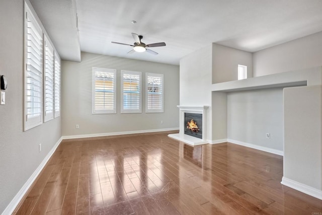 1440 Clearview Way, San Marcos, CA 92078 - unfurnished living room with ceiling fan, wood finished floors, a glass covered fireplace, and plenty of natural light