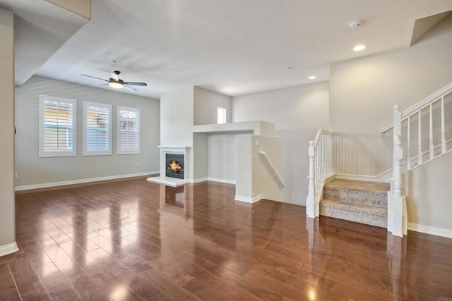 1440 Clearview Way, San Marcos, CA 92078 - unfurnished living room featuring wood finished floors, a ceiling fan, stairway, recessed lighting, and a warm lit fireplace