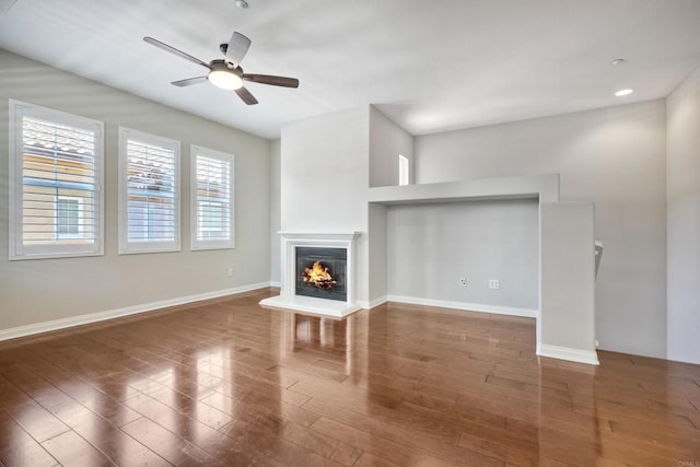 1440 Clearview Way, San Marcos, CA 92078 - unfurnished living room featuring wood finished floors, a ceiling fan, and a glass covered fireplace