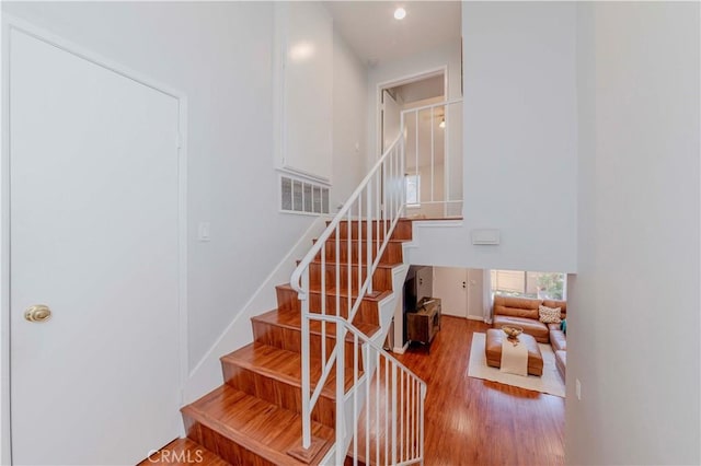 1755 Avenida Selva Unit 60, Fullerton, CA 92833 - staircase featuring wood finished floors, a high ceiling, and recessed lighting