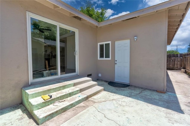 1101 Kensington Dr, Merced, CA 95340 - doorway to property with stucco siding and a patio
