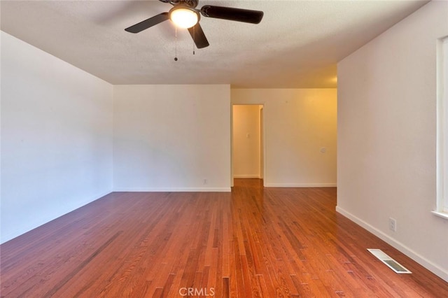 1101 Kensington Dr, Merced, CA 95340 - spare room featuring wood finished floors, ceiling fan, and a textured ceiling