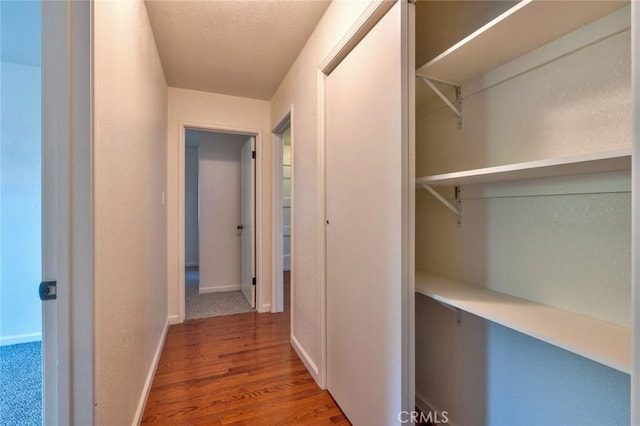 1101 Kensington Dr, Merced, CA 95340 - corridor with wood finished floors and baseboards