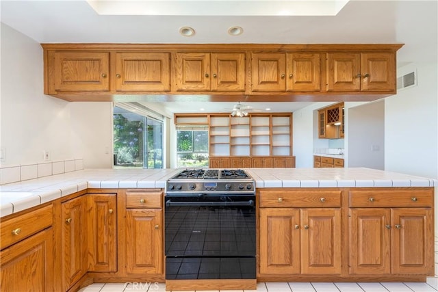 8 Via Subida, Rancho Palos Verdes, CA 90275 - kitchen with stainless steel range with gas cooktop, brown cabinetry, ceiling fan, light tile patterned flooring, and recessed lighting