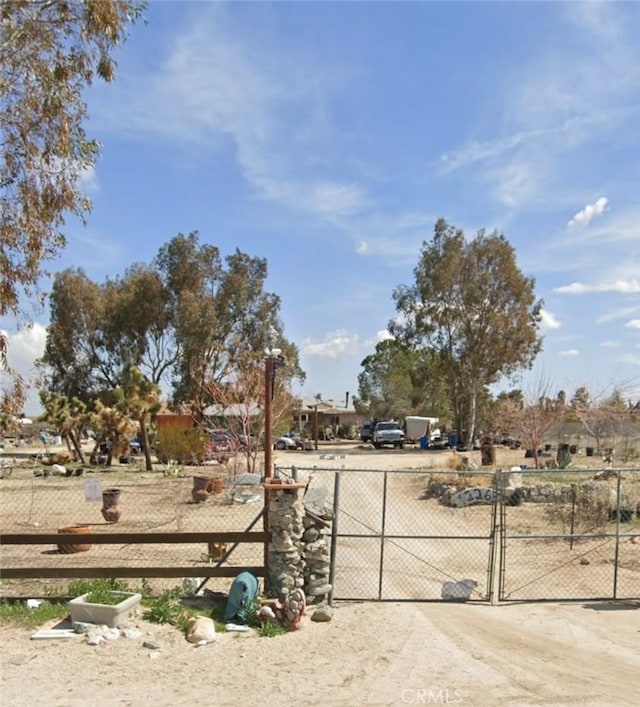 12263 Mountain Rd, Pinon Hills, CA 92372 - view of dirt / gravel driveway with a gated entry and a gate