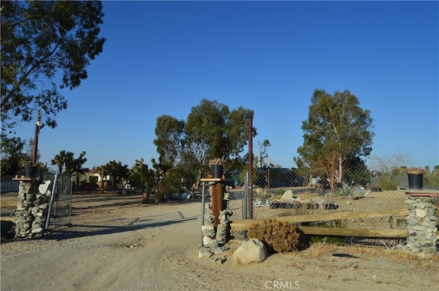 12263 Mountain Rd, Pinon Hills, CA 92372 - view of dirt / gravel driveway featuring a gated entry