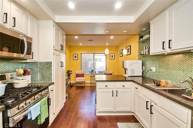 531 Juniper Way, La Habra, CA 90631 - kitchen featuring stainless steel appliances, a peninsula, dark countertops, white cabinetry, and recessed lighting